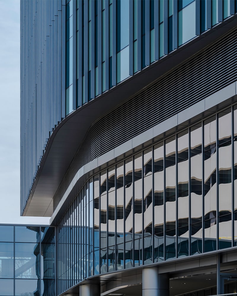 Close Up Of Building With Windows And Louvers