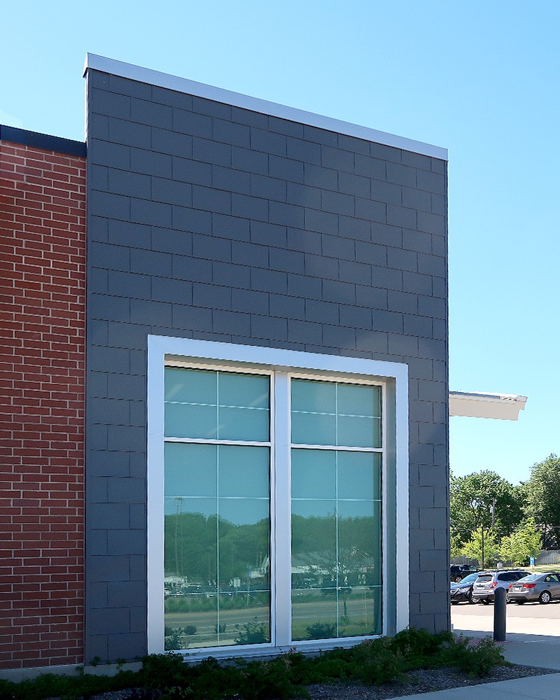 Close Up Of Grey Flat Lock Siding And Large Window