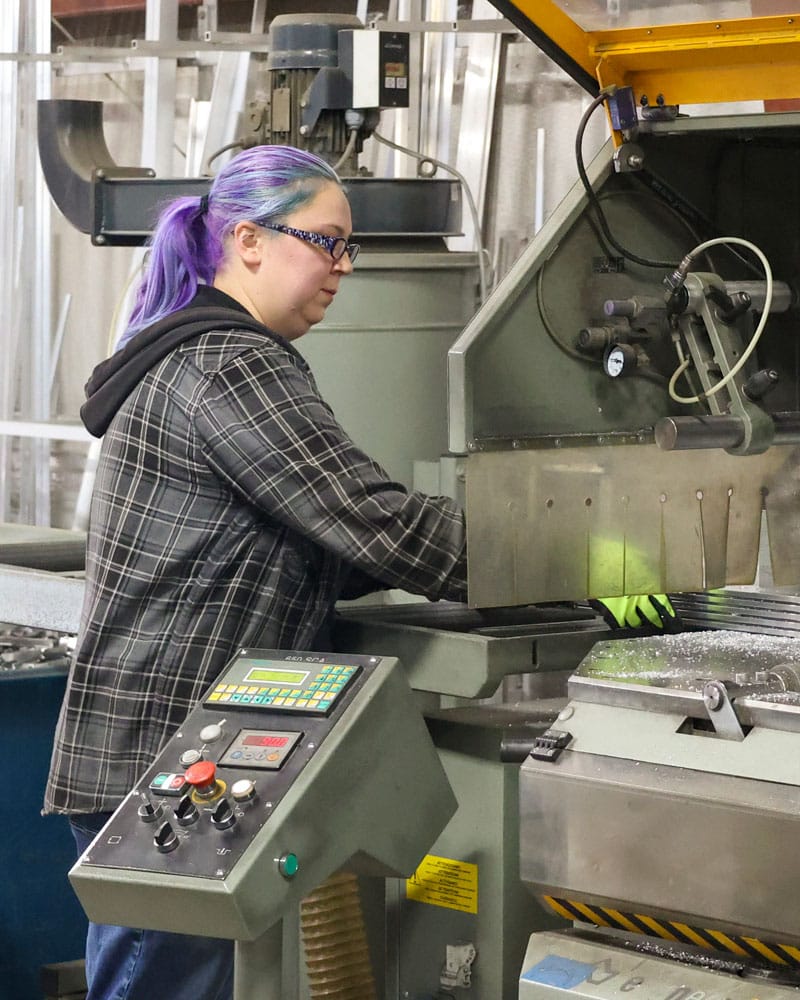 Employee Reviewing Part In Machine