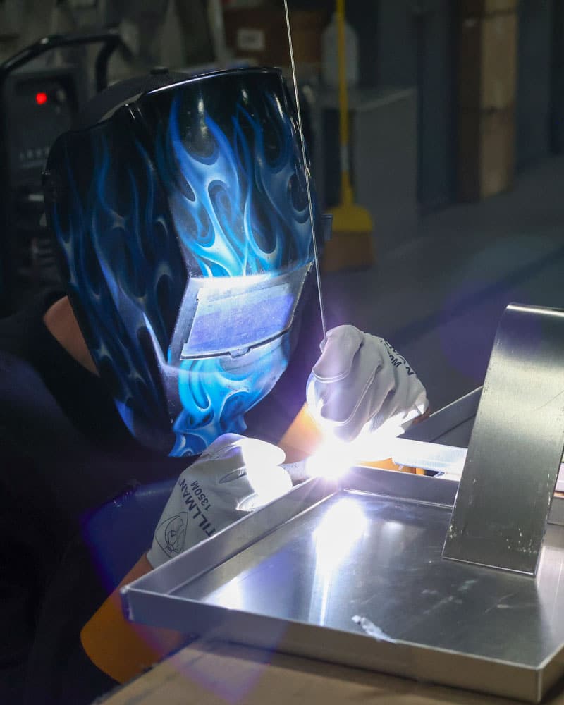 Employee Welding Metal Parts