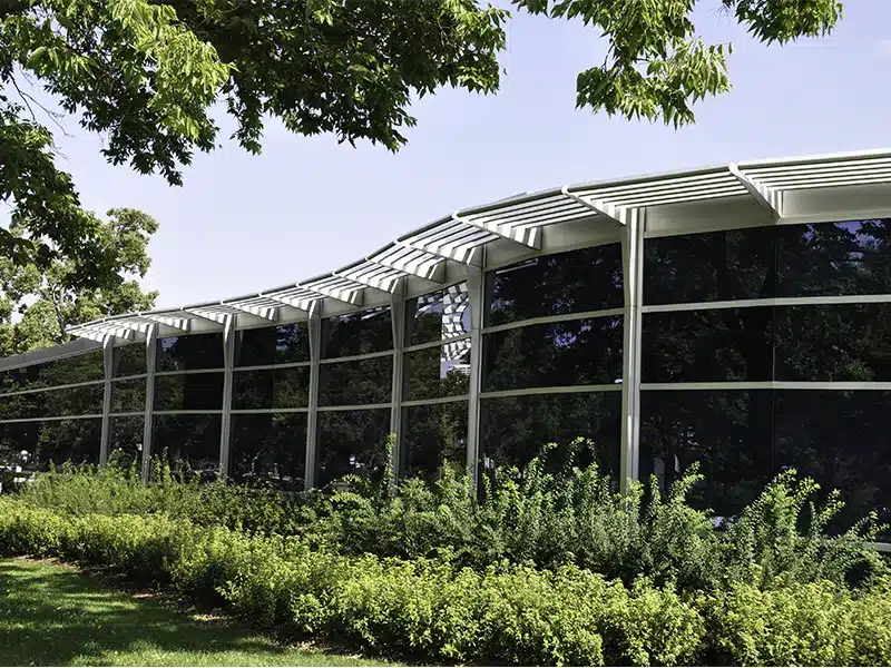 Glass Building with Silver Cantilevered Sun Control System